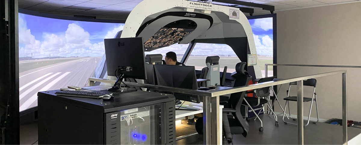 Behind-the-scenes view of the Flightdeck Solutions simulator installation at Air Premia South Korea, showcasing the integrated computer rack housing avionics suite and visual system computing hardware designed for continuous operation and performance reliability.