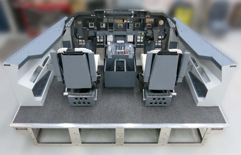 Custom wide-body flight deck demonstrator built by FDS for R&D, with crew seats on a raised platform